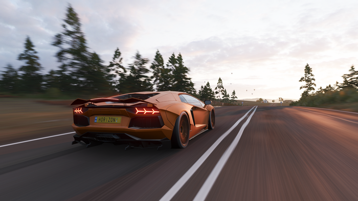 Orange Lamborghini Aventador driving on a road in Forza Horizon 4