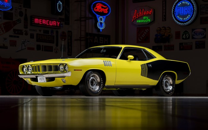 Yellow 1971 Plymouth Barracuda in a garage