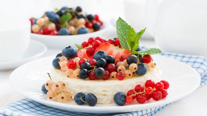 Dessert with fresh berries and mint on a plate