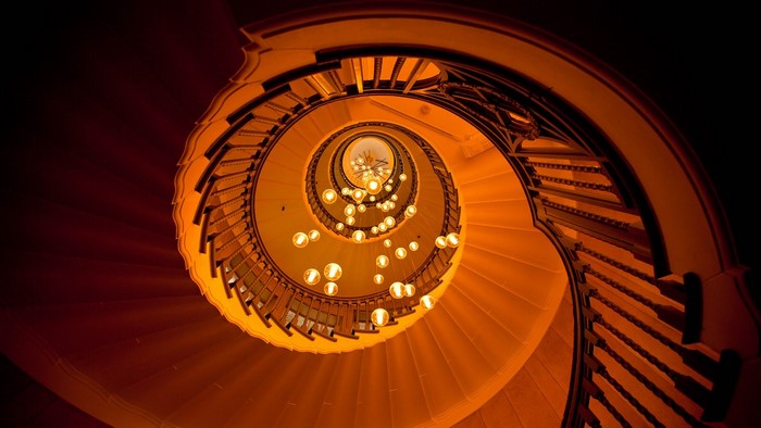Spiral staircase with hanging lamps, bottom view