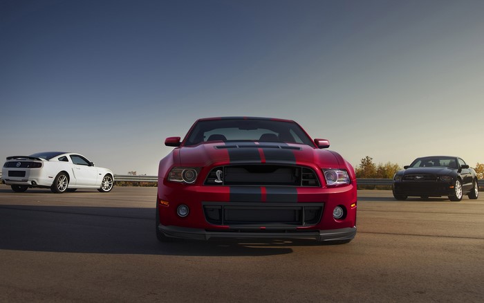 Three Ford Mustang Shelby GT500 cars on a road