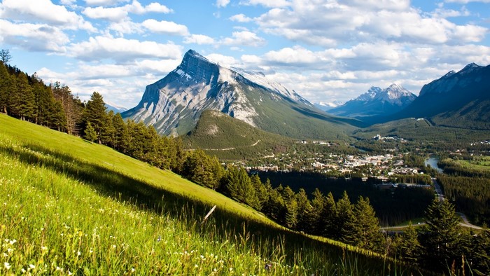 Mountain village nestled in a valley with green hills