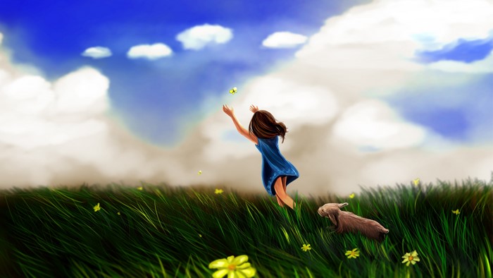 Girl reaching for butterfly in grassy field with dog