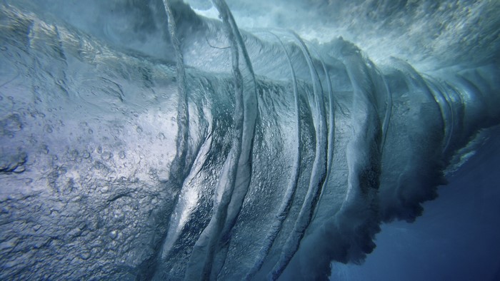 Underwater view of a breaking wave with bubbles