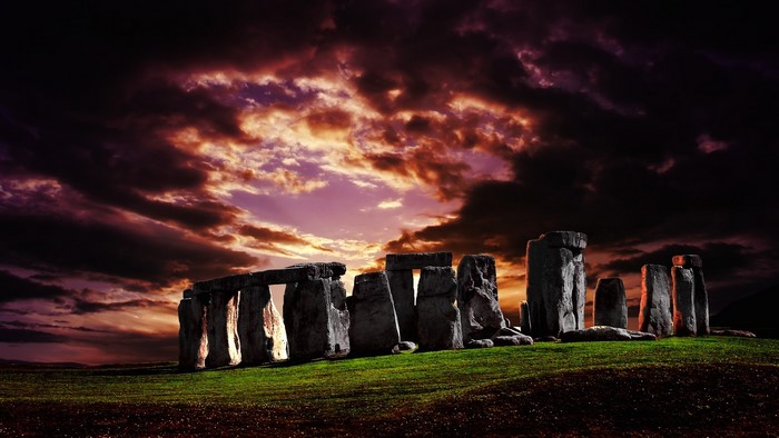 Stonehenge monument under a dramatic sunset sky