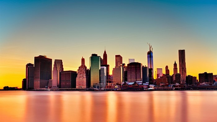 New York City skyline at sunset over the water