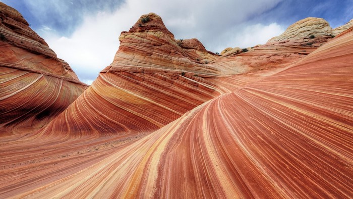 The Wave rock formation in Utah under a cloudy sky
