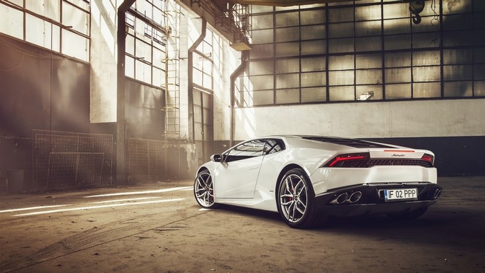 White Lamborghini Huracan in an industrial garage