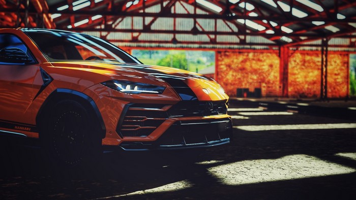 Orange Manhart Lamborghini Urus in a garage