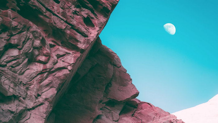 Bonobo album cover with textured rocks and moon