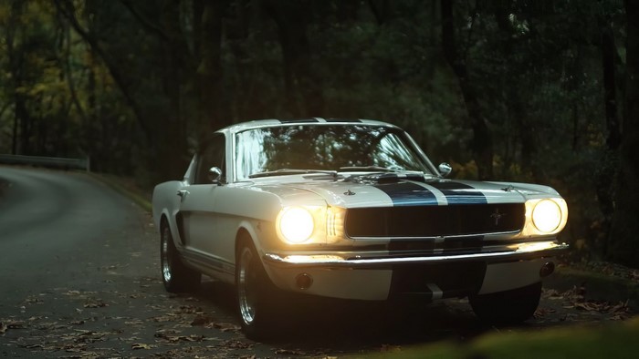 1965 Ford Mustang on a forest road