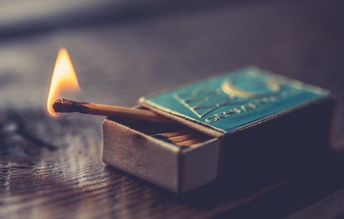 Burning matchstick in a matchbox