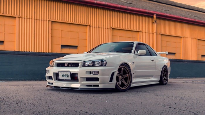 White Nissan Skyline GT-R R34 parked outdoors