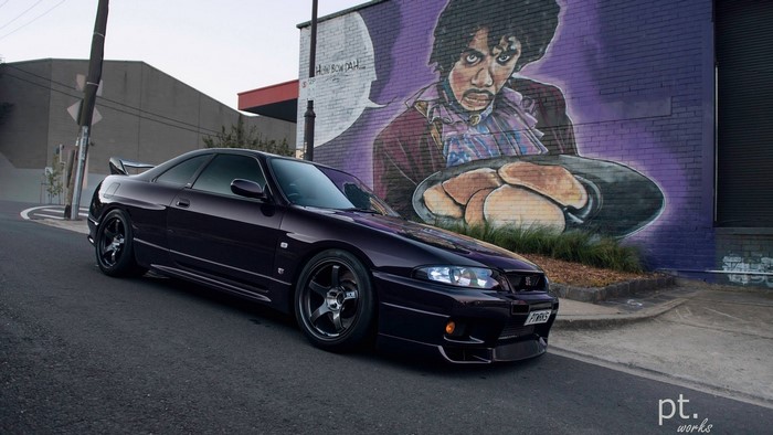 Nissan Skyline GT-R R33 parked near Prince mural