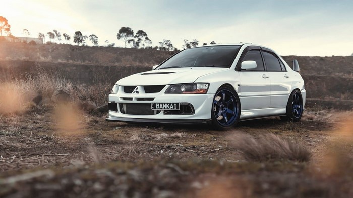 White Mitsubishi Lancer Evolution parked outdoors