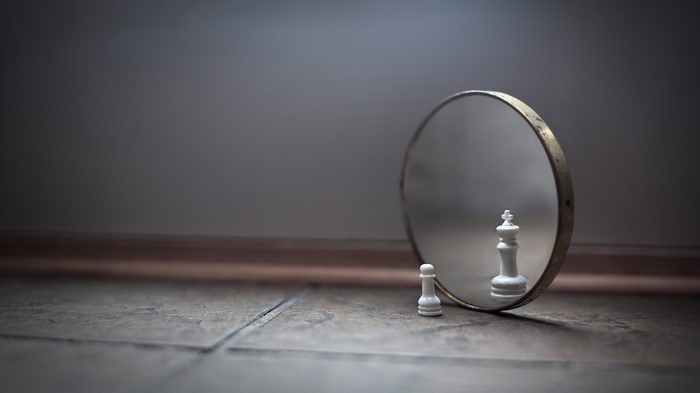 Chess Pawn and King Reflection in Mirror