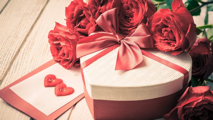Heart-shaped gift box with red roses and card