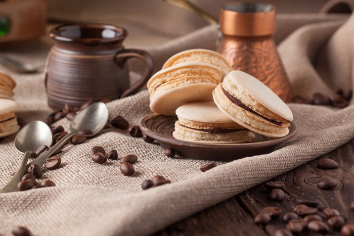 Macarons and coffee beans on a burlap cloth