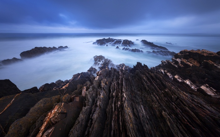 Rocky coastline with misty ocean waves