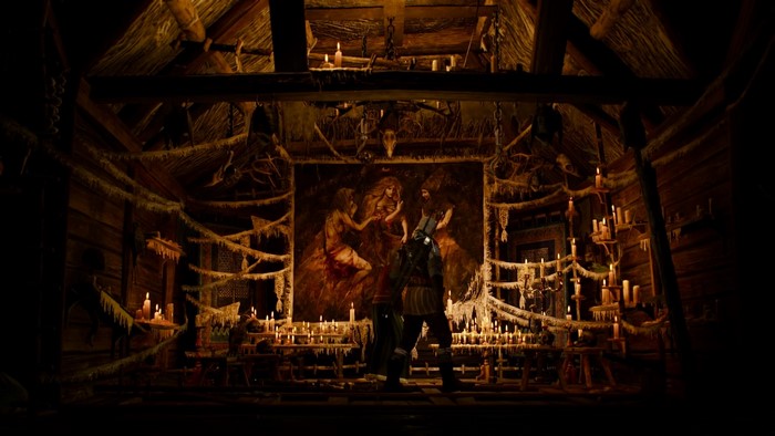 Geralt in a candlelit room with a painting