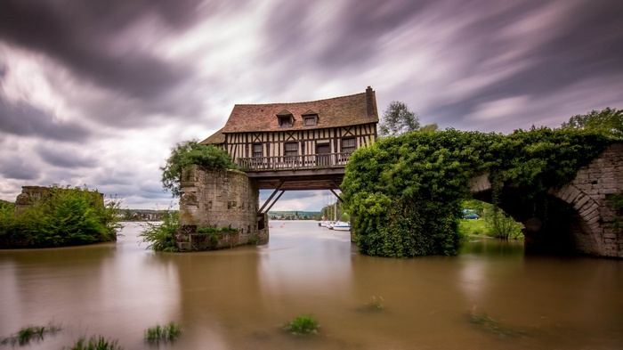 Half-timbered house on a bridge over a river