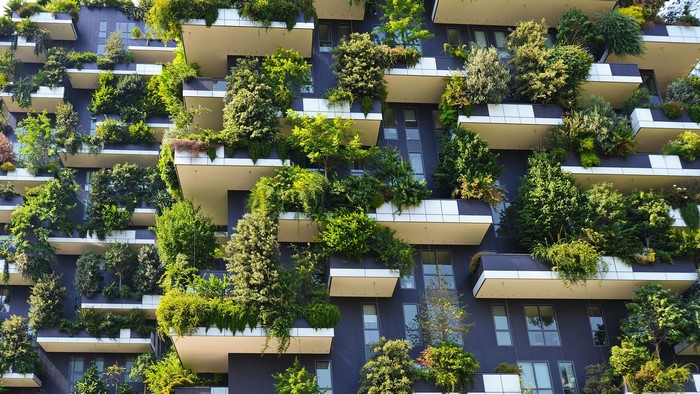 Vertical forest building with abundant plants on balconies