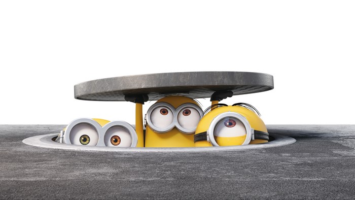 Minions peeking out from a manhole cover