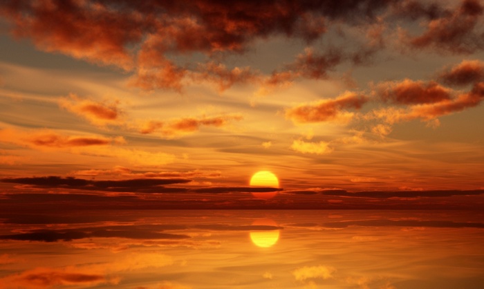 Sunset over the ocean with reflection