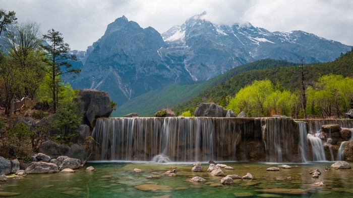 Waterfall in Blue Moon Valley with Snowy Mountains