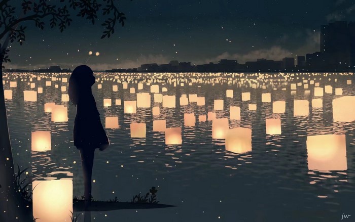 Silhouette of a girl watching lanterns on water