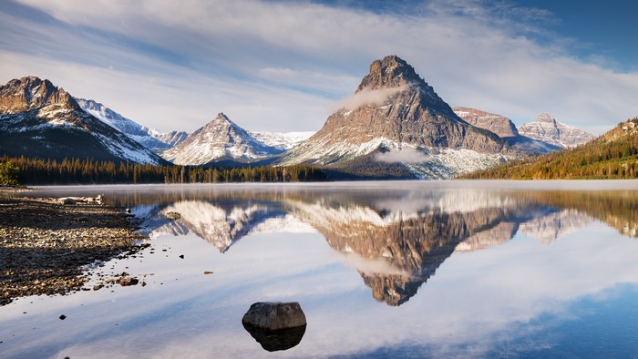 Mountains reflected in a lake with clouds