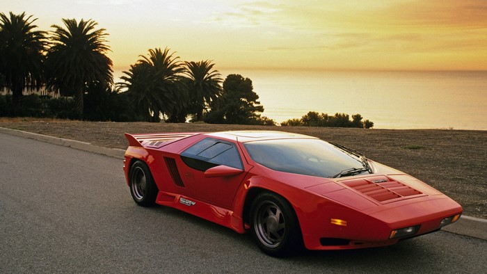 Red Vector W8 Twin Turbo supercar at sunset