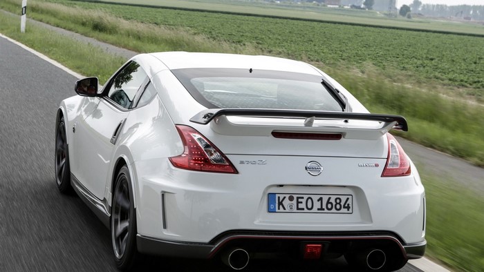 White Nissan 370Z Nismo driving on a road