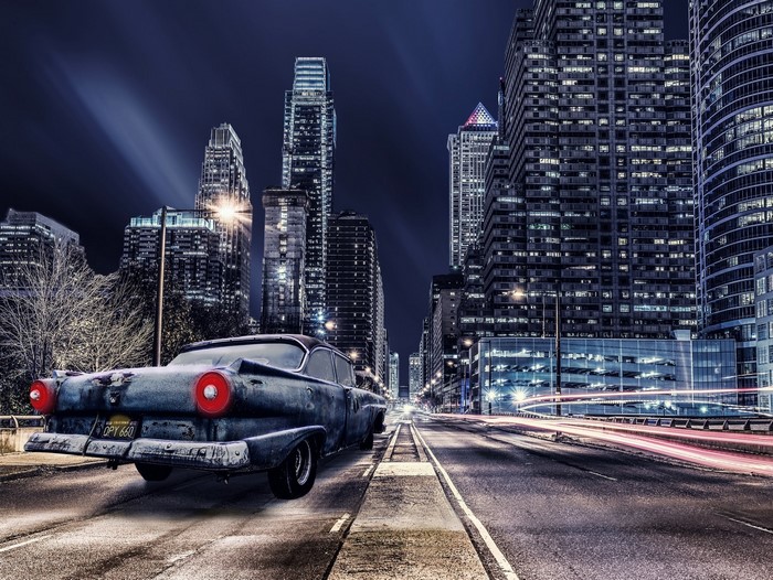 Vintage car on a city street at night