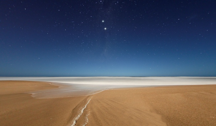 Beach at night with stars and ocean
