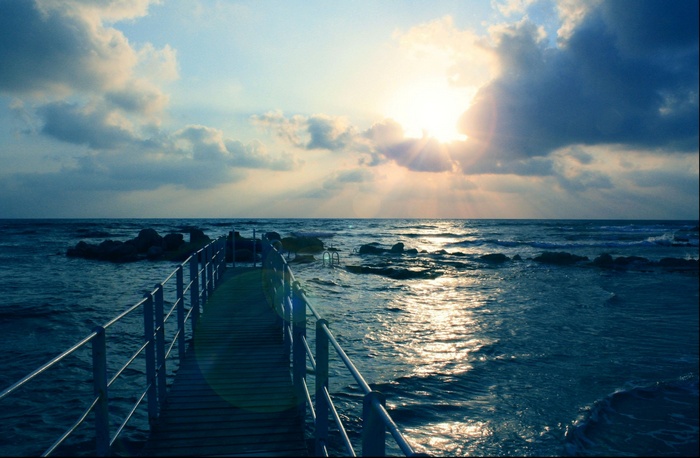 Pier over the ocean at sunset