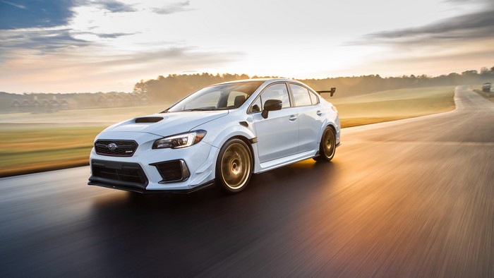 White Subaru WRX STI on a road with motion blur