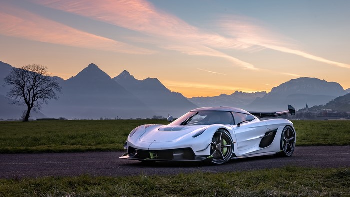 White Koenigsegg Jesko supercar on a road with mountains