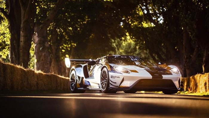 Ford GT Mk II race car on a tree-lined road