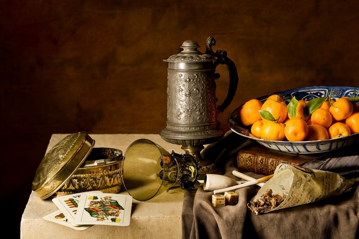 Still life with playing cards, pewter tankard, and oranges