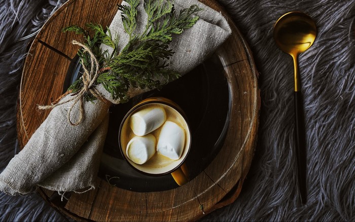 Hot chocolate with marshmallows on a wooden plate