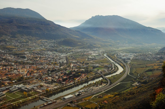 River flowing through a valley with mountains and a city