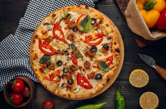 Pizza with tomatoes, mushrooms, olives, and peppers