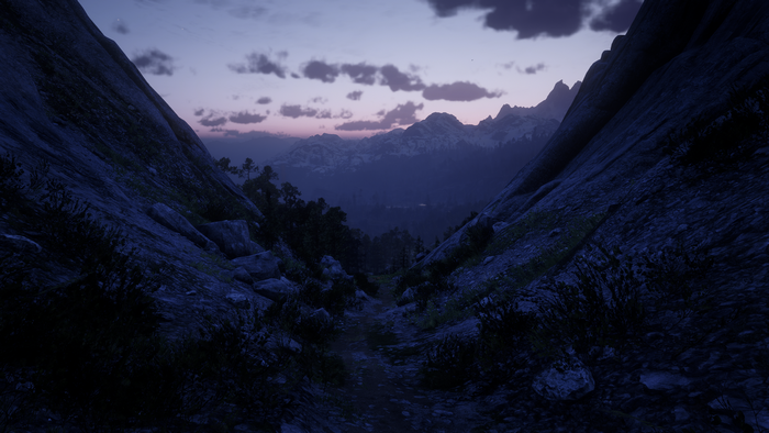 Red Dead Redemption 2 screenshot of a mountain pass at dusk