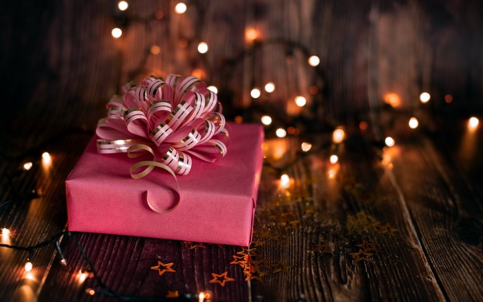 Pink gift box with bow and Christmas lights