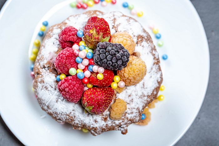 Chocolate cake with berries and sprinkles