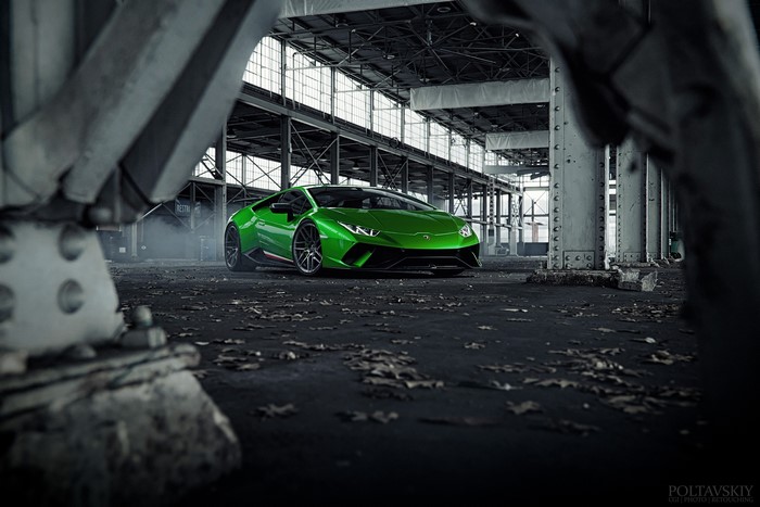 Green Lamborghini Huracan in an abandoned industrial building