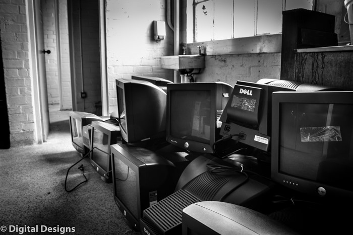 Pile of old CRT monitors and Dell computers