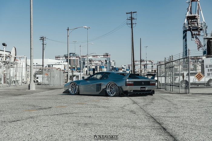 Silver Ferrari Testarossa 512 TR parked at industrial site