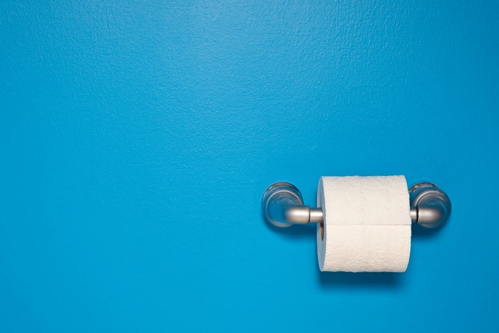 Toilet paper roll on a blue wall